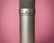Large Condenser Microphone majestically set against a soft pink background.